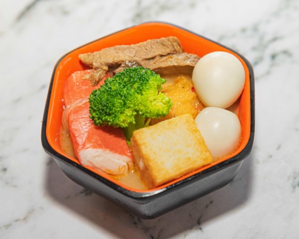 Beef bone broth delivery bowl with broccoli, tofu, crab stick and quail egg